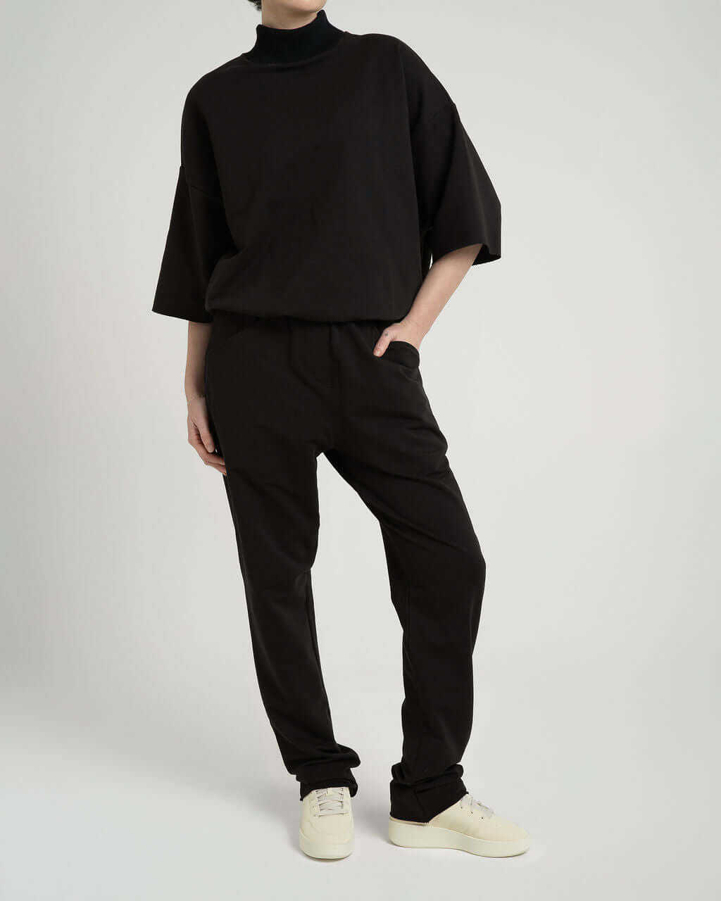 Model wearing black French Terry cotton trousers with matching oversized top for ultimate comfort and style.