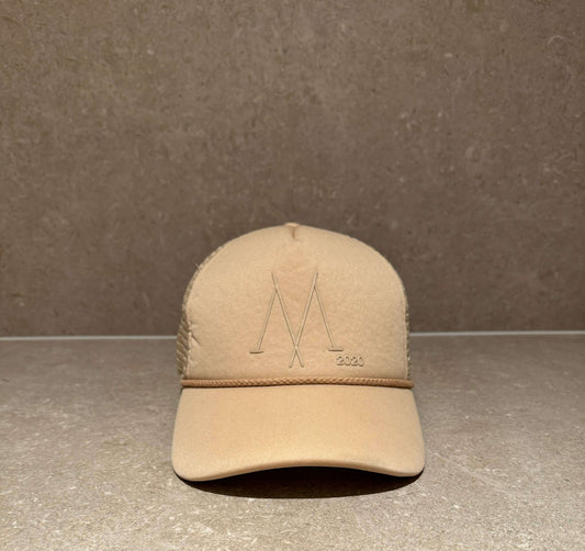 Foam front trucker cap in taupe beige with SnapBack closure and puff print Mantle 2020 logo.