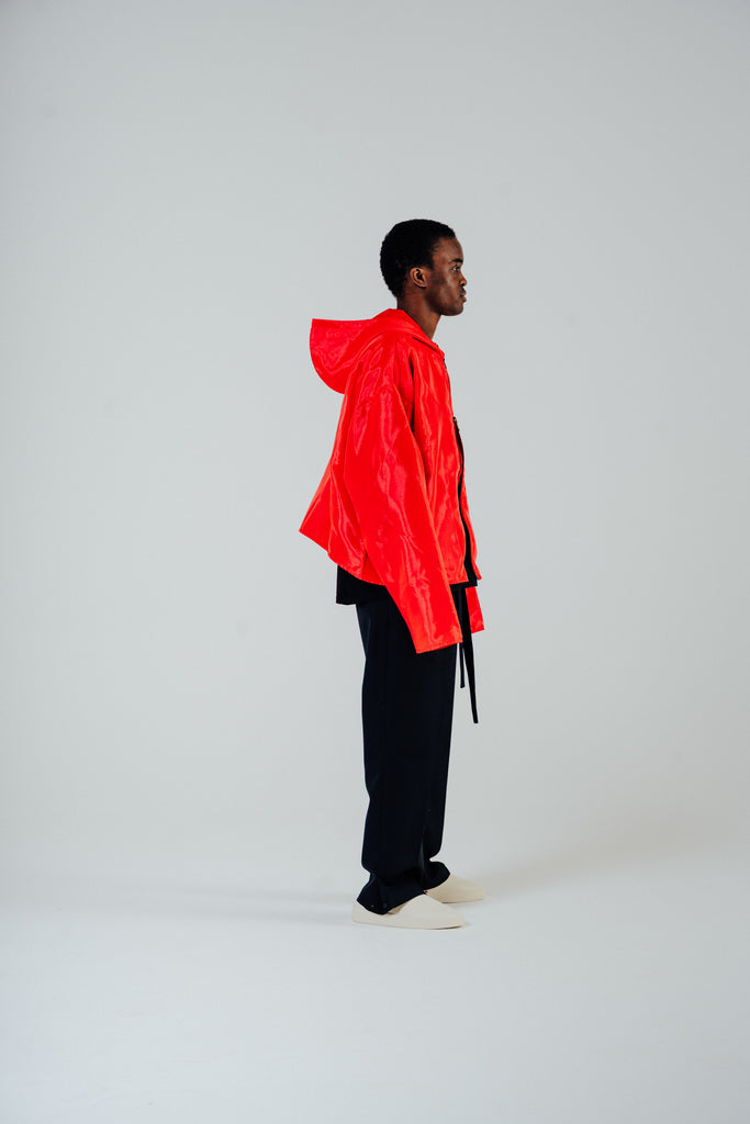 Model in flame red organza hooded zip jacket, showcasing boxy oversized fit and cropped body style.