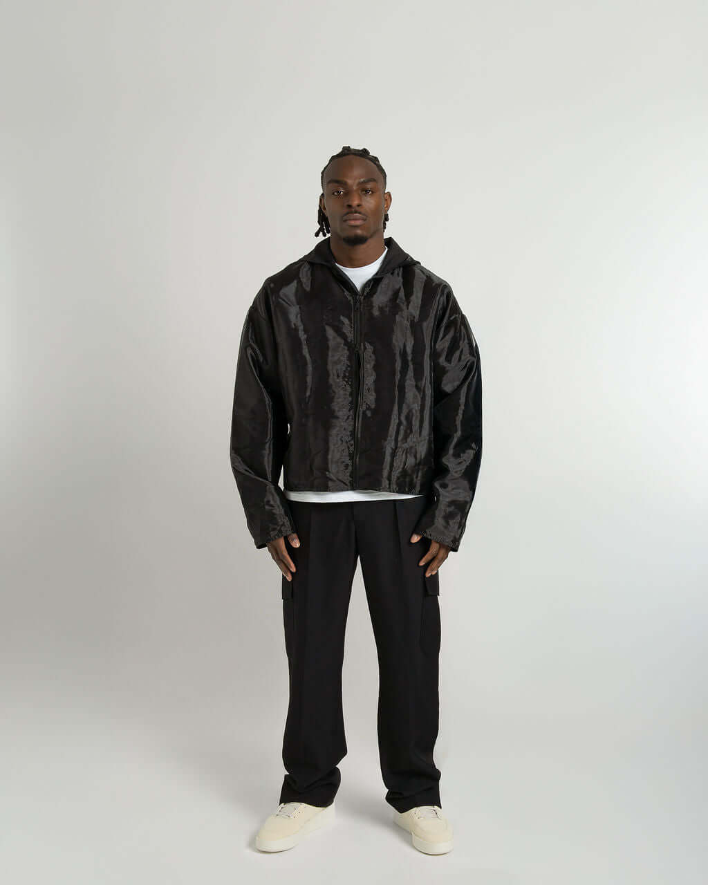 Model wearing the "Virgil" black organza hooded zip-up jacket, showcasing its oversized fit and cropped style.