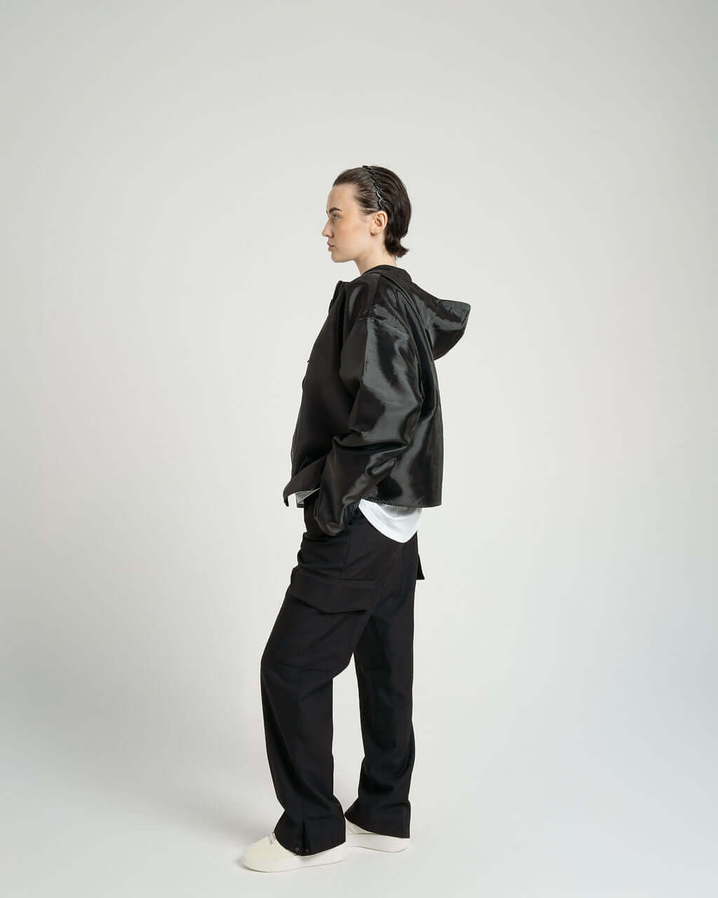 Model wearing the black 'Virgil' Organza hooded zip up jacket, showcasing its oversized fit and cropped design.