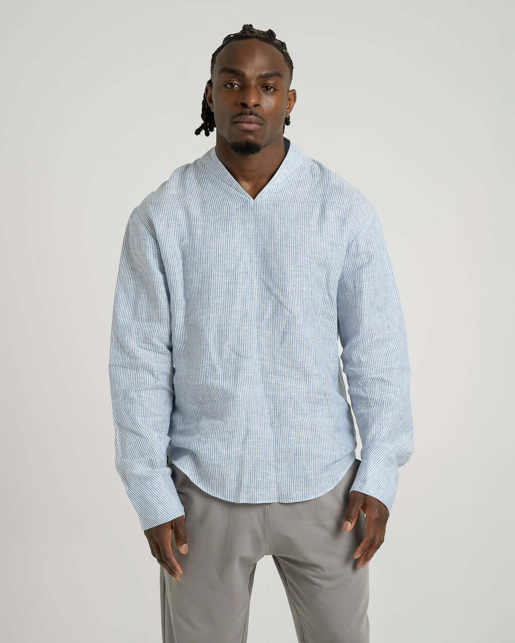 Blue and white striped linen long sleeve shirt with V-neck, relaxed fit, worn by a model.