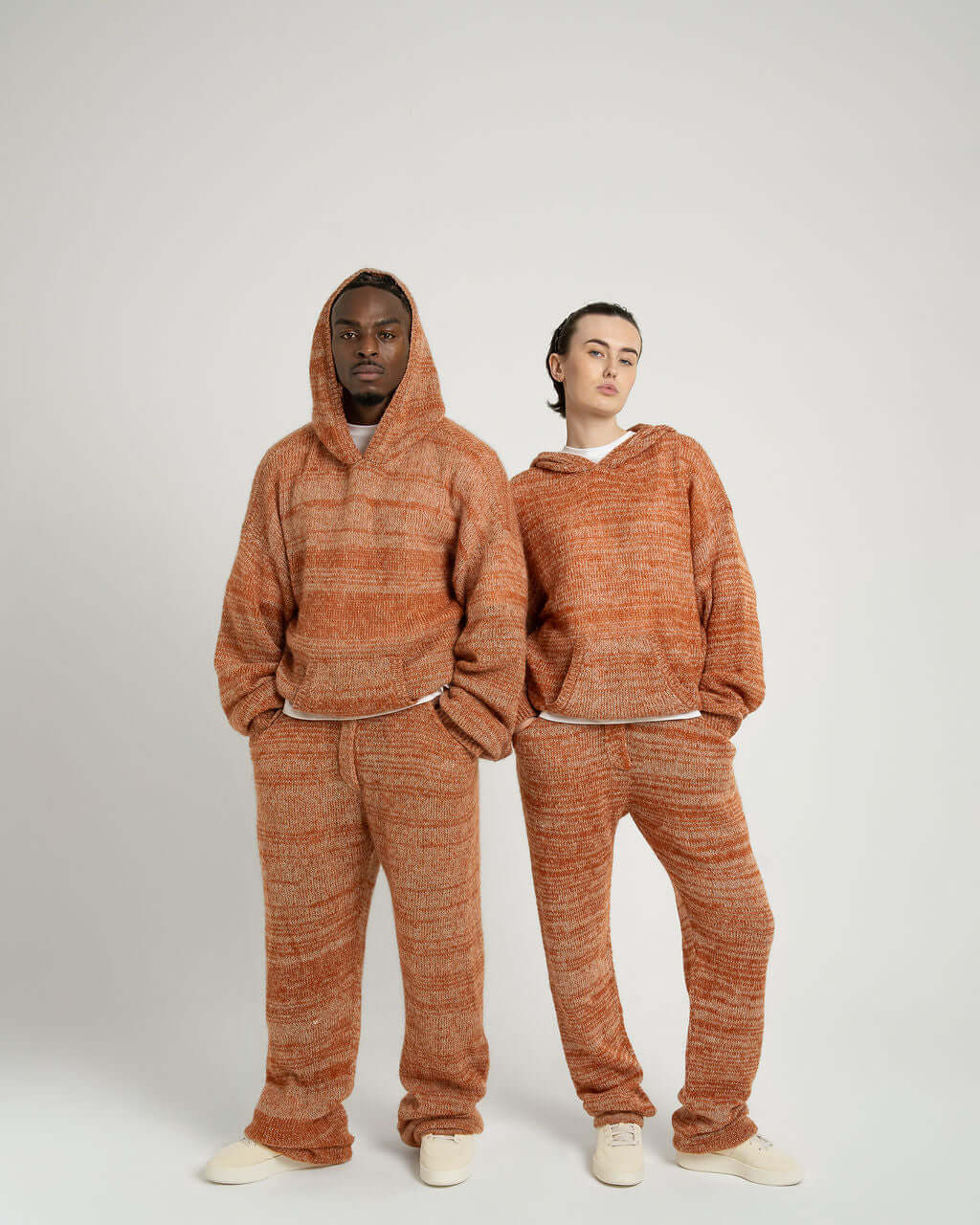 Modeling a Kid Mohair Blend Knitted Hoody and matching pants in Evening Sun, showcasing oversized fit and unique color blend.