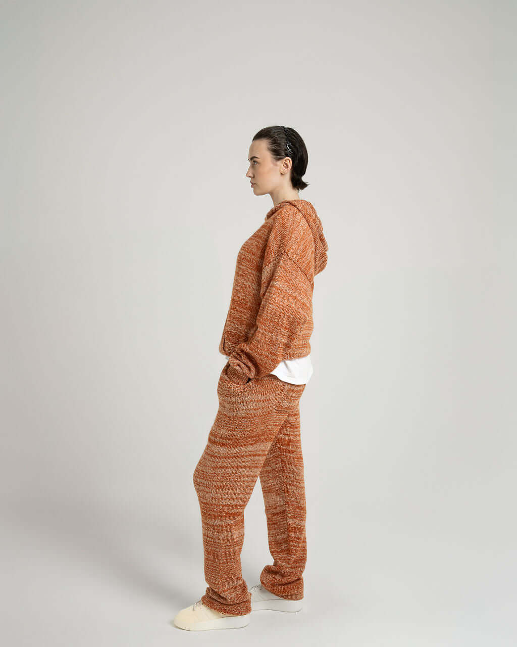 Side view of a model wearing a Kid Mohair Blend Knitted Hoody in Evening Sun, showcasing its oversized fit and softness.