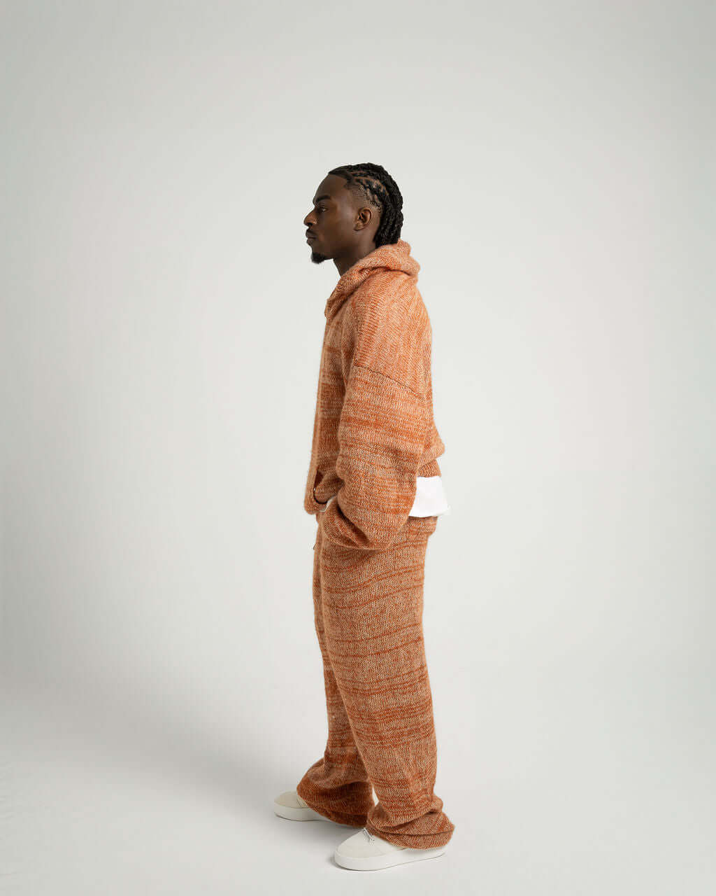 Model wearing Kid Mohair Blend Knitted Trousers in Evening Sun, showcasing oversized fit and unique color effect.