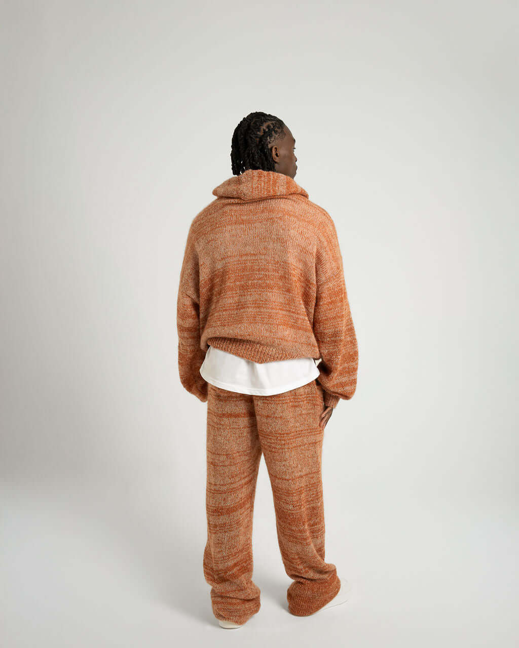 Back view of a model wearing an oversized Kid Mohair Blend Knitted Hoody in Evening Sun with matching pants.