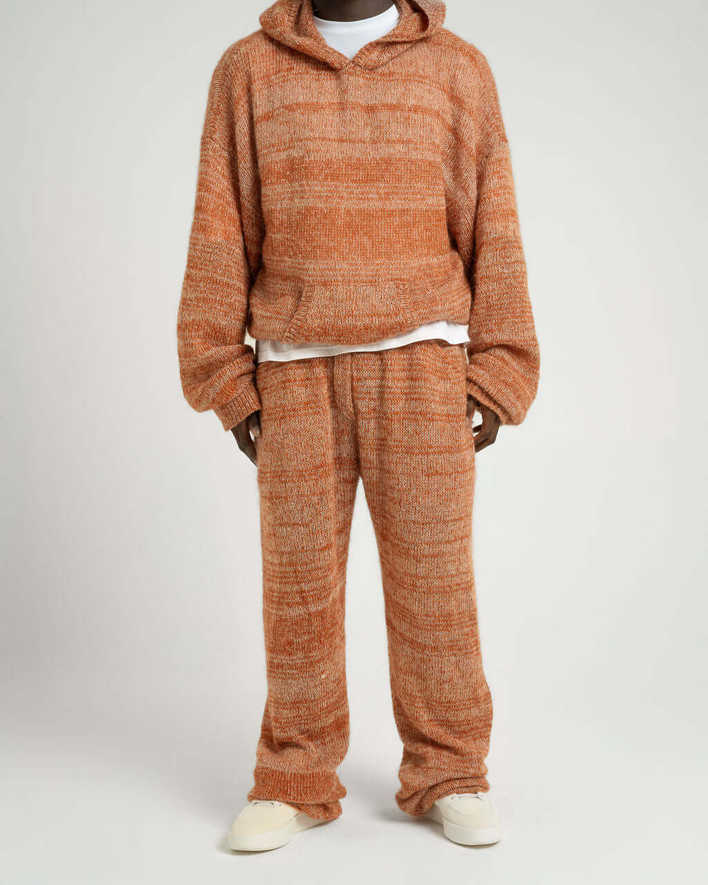Kid Mohair blend knitted trousers and hoodie set in evening sun, featuring loose fit and unique two-tone yarn effect.