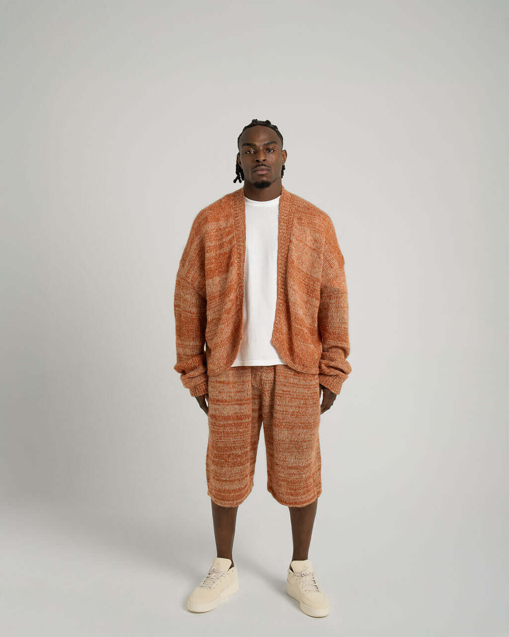 Model wearing Kid Mohair blend knitted shorts and cardigan in orange, showcasing relaxed fit and ultimate softness.