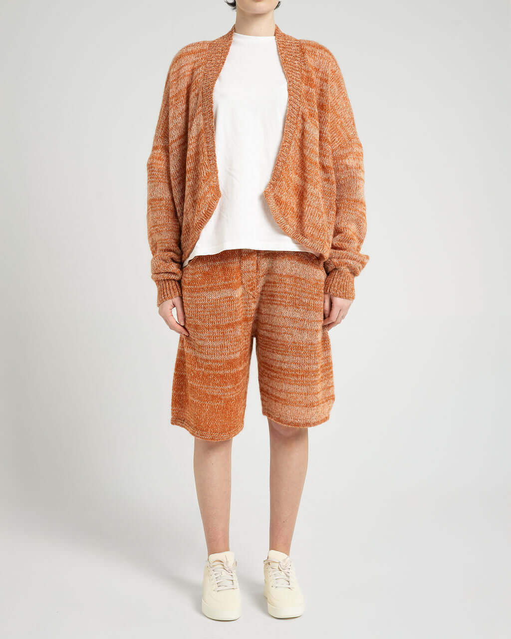 Model wearing Kid Mohair Blend Knitted Shorts in Evening Sun, paired with a white top and oversized cardigan.
