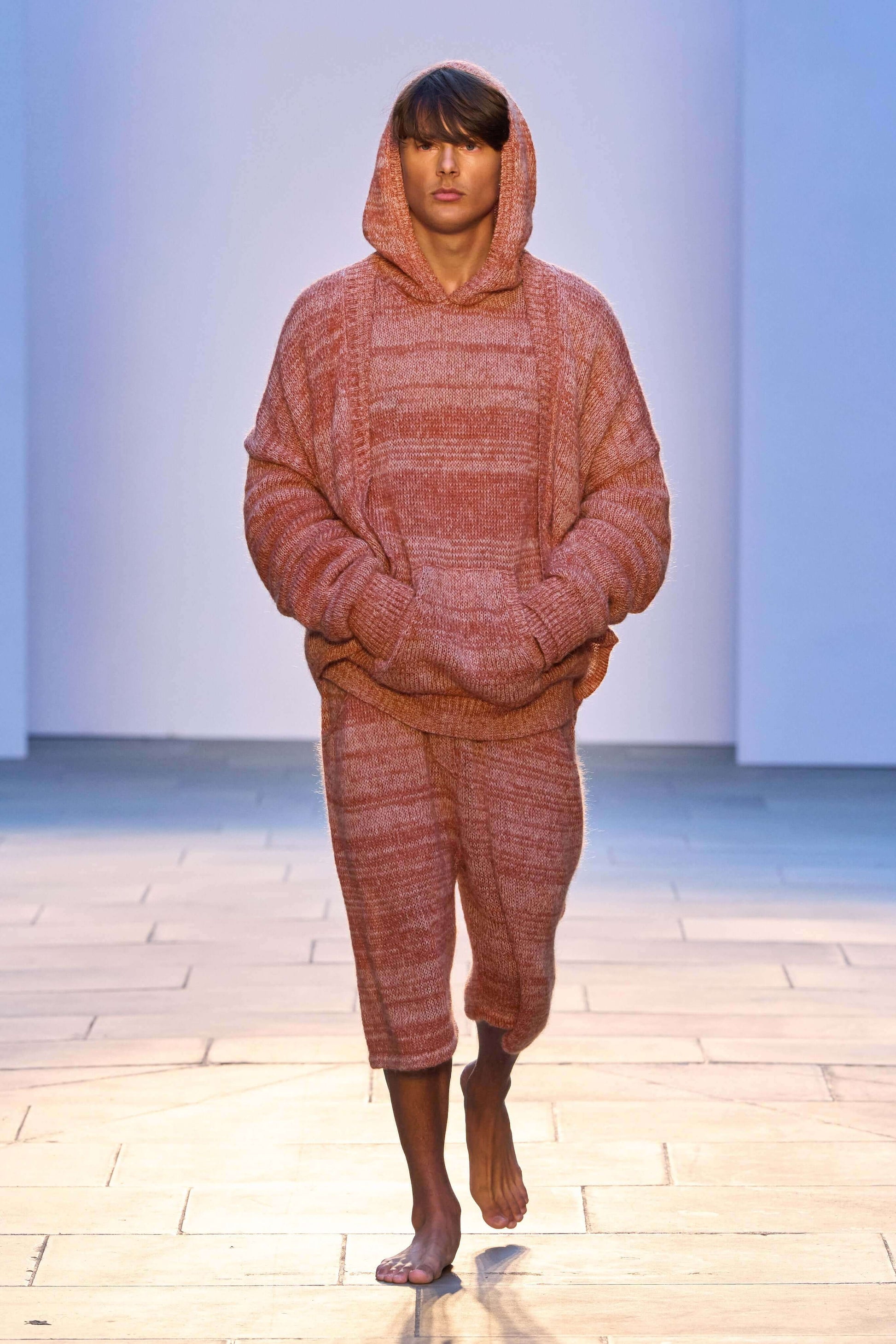 Model wearing Kid Mohair blend knitted hoody in evening sun color, showcasing oversized fit and kangaroo pocket.